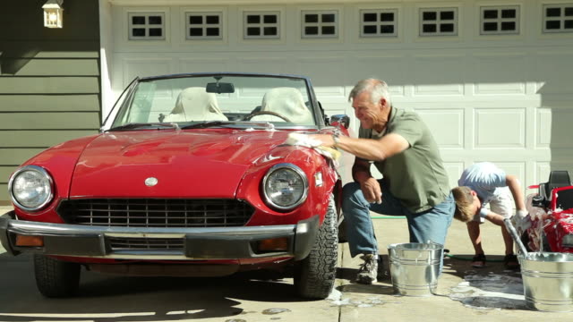 Grandfather and Grandson wash cars together
