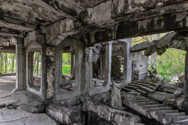istock Interior of ruined, concrete building, abandoned in forest 1147289397