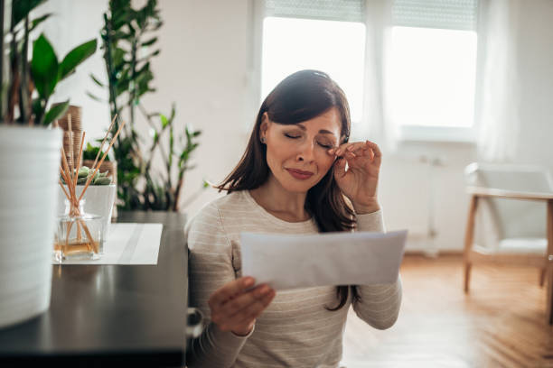 istock Woman reading a letter and crying. 1147289488