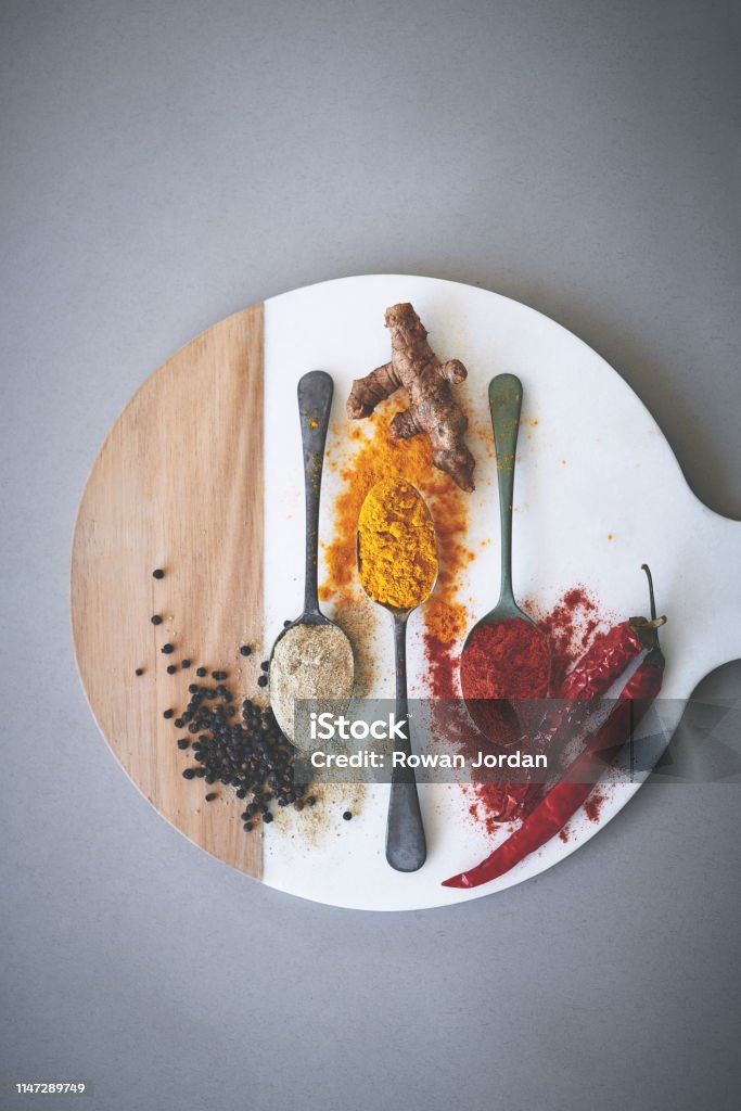 Spices contribute rich flavor to food without adding any calories Shot of an assortment of spices Mixing Stock Photo