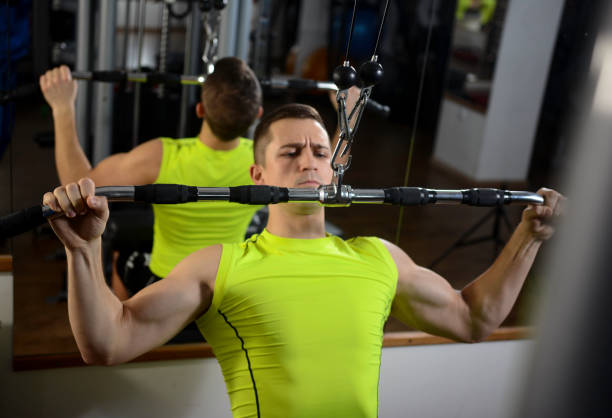 istock Bodybuilder working out in the gym on lat machine 1147291037
