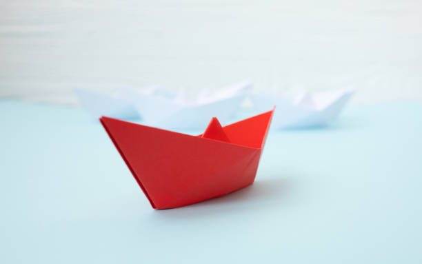 istock Paper ship on blue background. Conversation concept. 1147291170