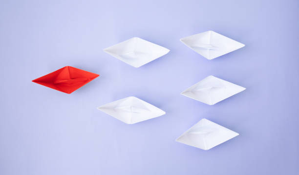 istock Paper ship on blue background. Conversation concept. 1147292220