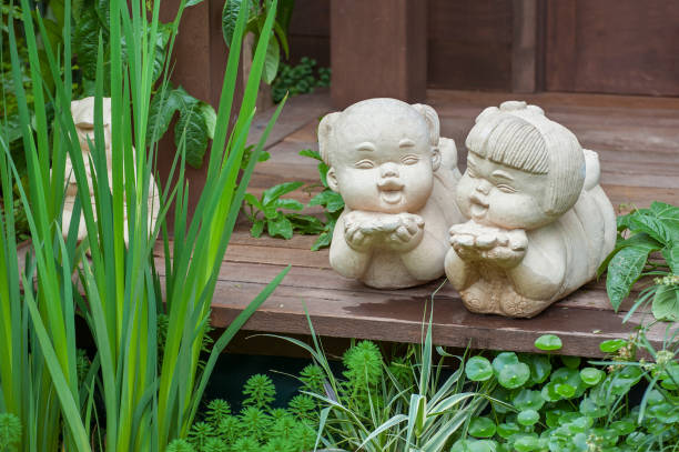 white stone boy and girl love couple sculpture in garden