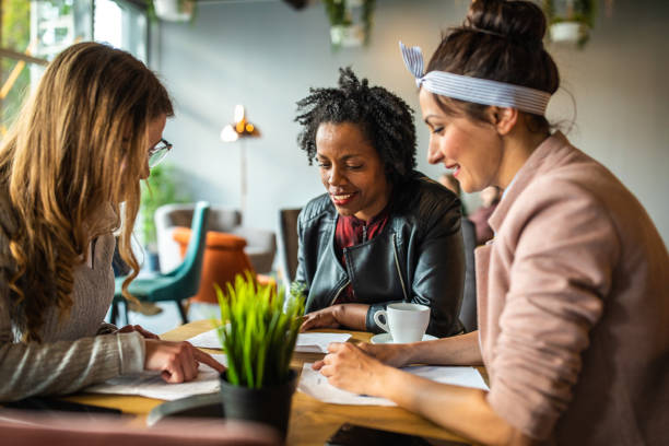 istock Beautiful female coworkers working from cafe 1147292359
