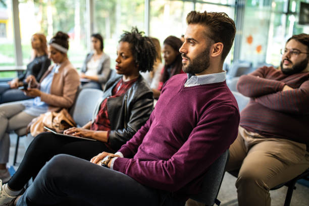istock Coworkers sitting on business conference 1147292484