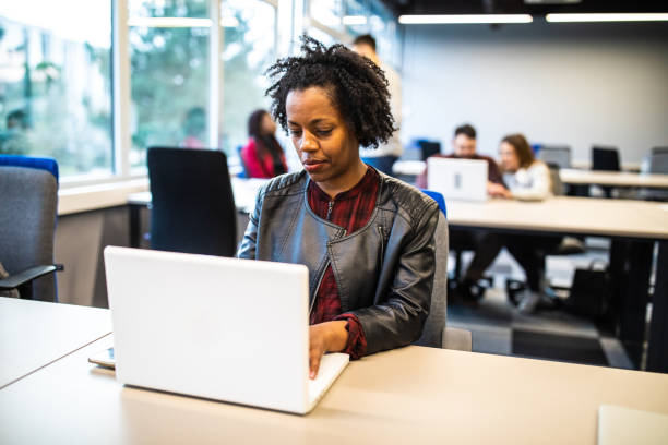 istock Concentrated African woman using laptop in the office 1147293969