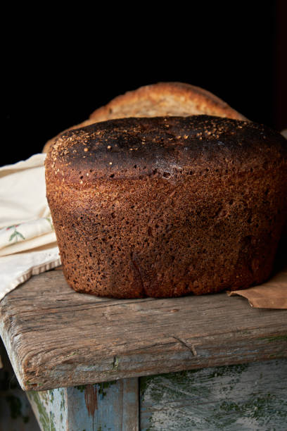 istock whole baked rye bread lying on a wooden table 1147293973