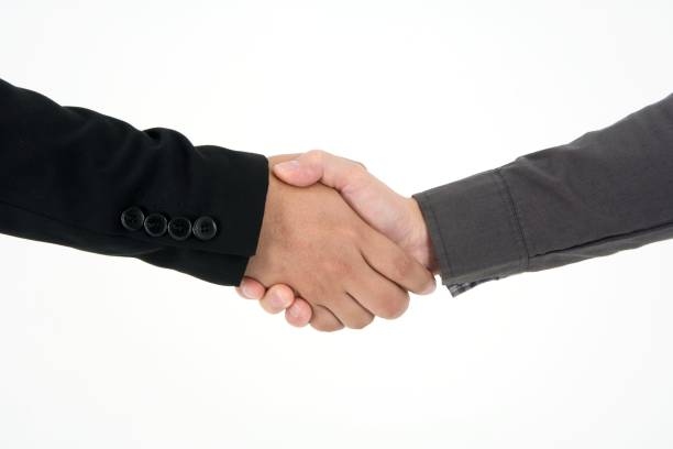 istock Two businessman post to shake hand to commit deal and celebrate success isolated on white background 1147294363