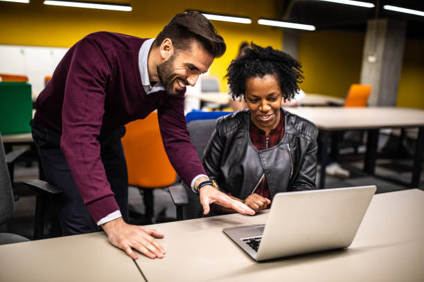 istock African woman and handsome man working on lap top 1147294457