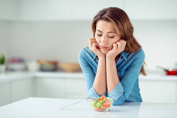 close-up portrait of her she nice lovely charming attractive sad bored dull disappointed brown-haired lady looking at new green detox vitamin salad in light white interior style kitchen - portion imagens e fotografias de stock