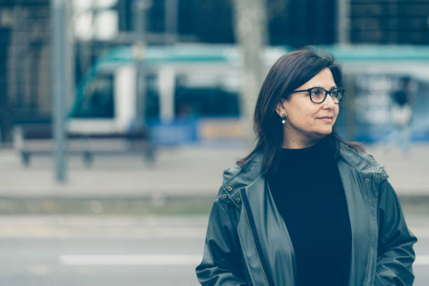 mujer de mediana edad caminando en barcelona - desaturado fotografías e imágenes de stock