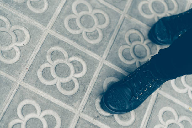 Woman's shoes walking on the sidewalk with the typical design of Barcelona.
