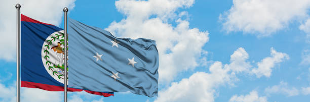 istock Belize and Micronesia flag waving in the wind against white cloudy blue sky together. Diplomacy concept, international relations. 1147296542