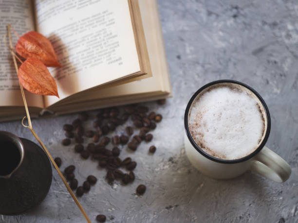 istock Milk coffee boiled in cezve, old book on gray background 1147297671