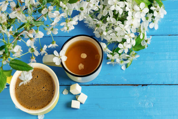 istock Spring tea and coffee . Cherry blossom branch on wooden blue background with copyspace 1147297747
