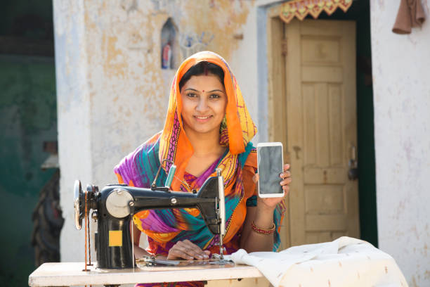 istock Indian women stitching cloths by machine at home - Stock image 1147298883