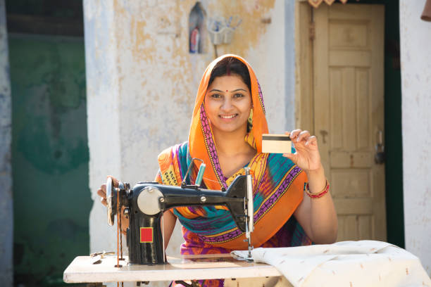 istock Indian women stitching cloths by machine at home - Stock image 1147299619