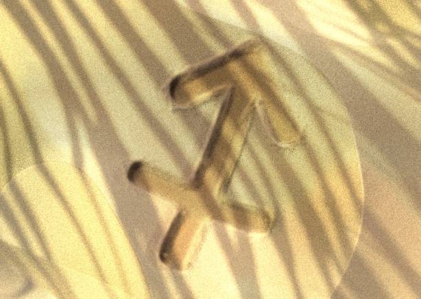 Ancient Emblem of Sagittarius Zodiac Symbol on Dark Stone Surface Background Illuminated with Blue Light., offering a mysterious and futuristic aesthetic