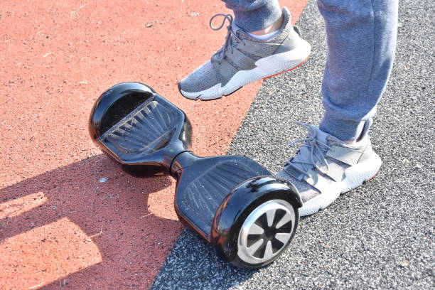 istock young man riding on the Hoverboard in the park 1147301042