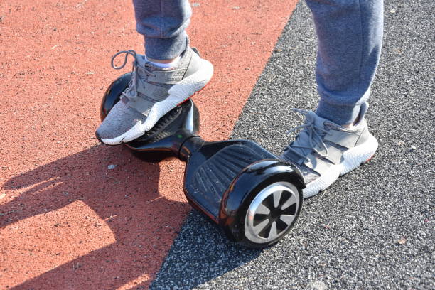 istock young man riding on the Hoverboard in the park 1147301045