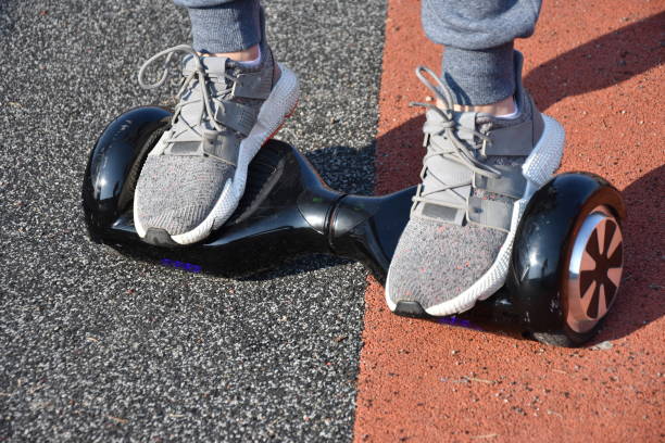 istock young man riding on the Hoverboard in the park 1147301047
