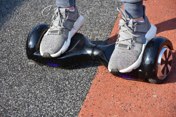istock young man riding on the Hoverboard in the park 1147301056