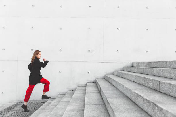 istock Woman climbing up the stairs 1147302906