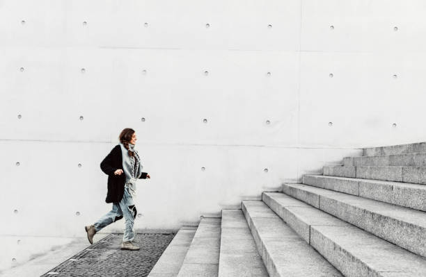 istock Woman climbing up the stairs 1147302972