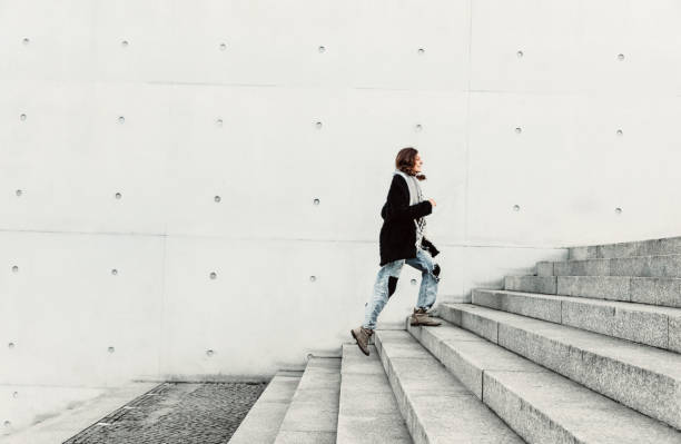 istock Woman climbing up the stairs 1147303078