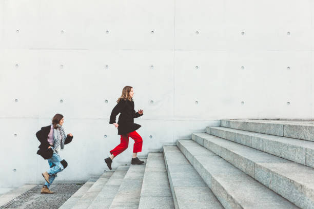 istock friends running up steps in urban setting 1147303193