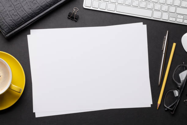 istock Office workplace table with blank paper page 1147303212