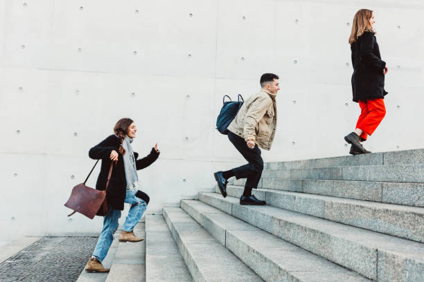 istock friends running up steps in urban setting 1147303677