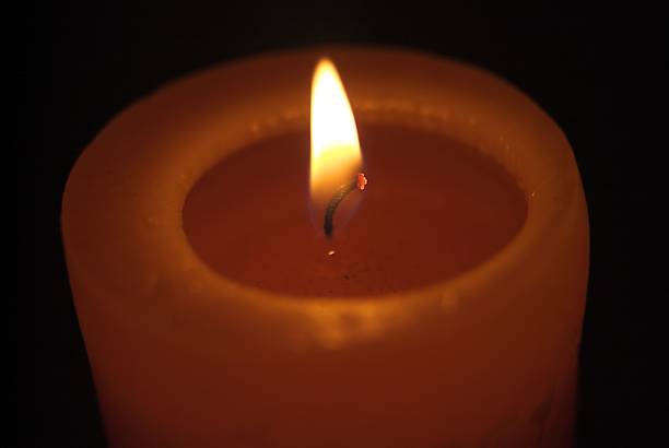 istock Candle flame close up on a black background 1147303935