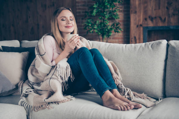 Photo portrait of charming positive pleased calm peaceful one single having free time attractive closing eyes she her lady sitting on divan Photo portrait of charming positive pleased calm peaceful one single having free time attractive closing eyes she her lady sitting on divan. plaid couch stock pictures, royalty-free photos & images