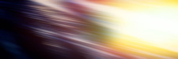 istock Abstract blurred background diagonal light lines on a dark multi-colored background and a bright yellow spot. 1147305124