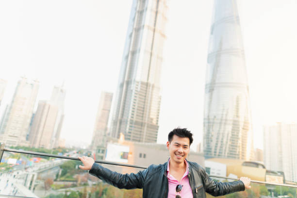 Portrait of a young Chinese posing at the building terrace in Shanghai.