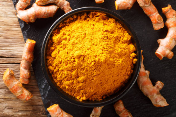 istock Fresh turmeric spice in a bowl and root close-up. horizontal top view 1147306935