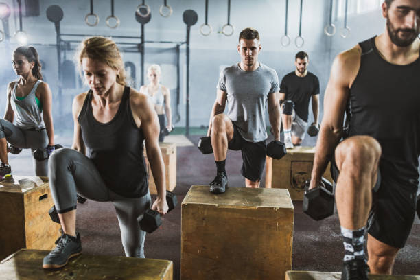 istock Athletic people having cross training with dumbbells in a gym. 1147308308