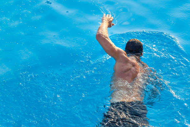 istock Athlete swimming in swimming pool with copy space 1147308636