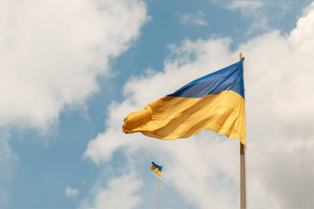 istock Ukrainian national flags on a flagpoles against a blue sky 1147308706