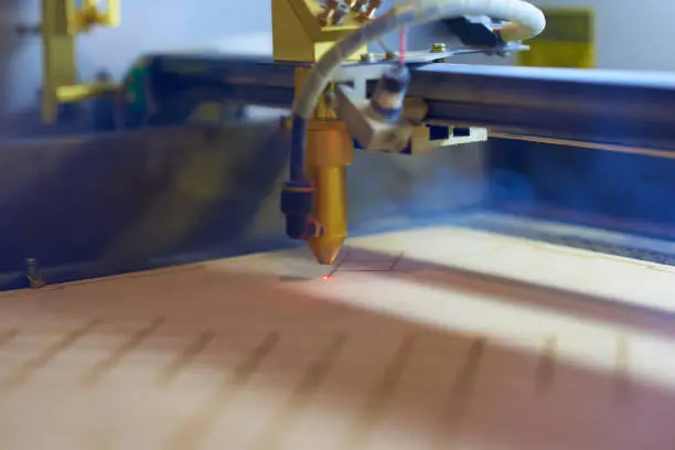 Photo of plywood laser cutting process close up