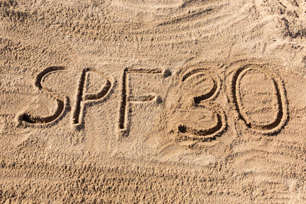 istock Sun protect factor thirty concept. SPF 30 word written on the beach 1147309829