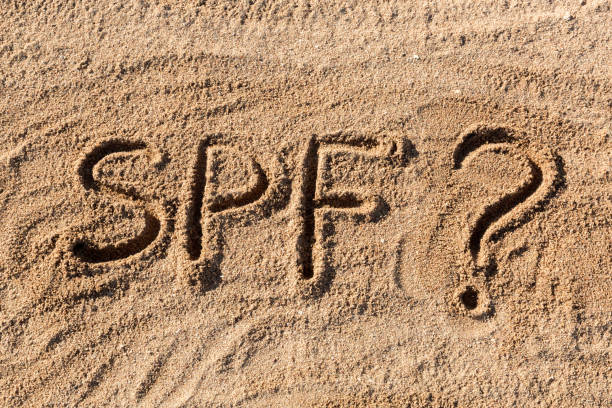 istock Sun protect factor concept. SPF word written on the beach with question mark 1147309856
