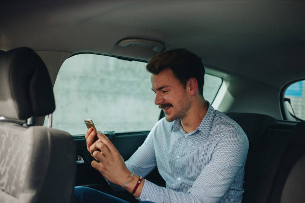 istock Businessman in the car texting 1147309879