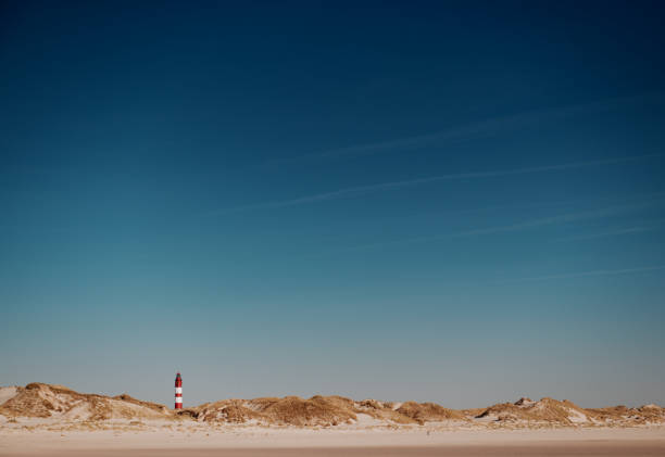 Lighthouse in the dunes Lighthouse in the sunlight (XXXL) amrum stock pictures, royalty-free photos & images