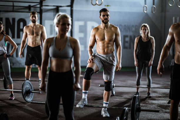 istock Group of athletes taking a break from weightlifting in a gym. 1147311100