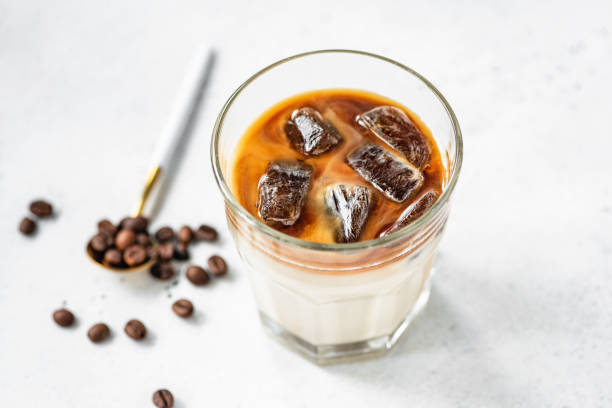 グラスにミルク入りアイスコーヒー - カフェラテ　アイス ストックフォトと画像