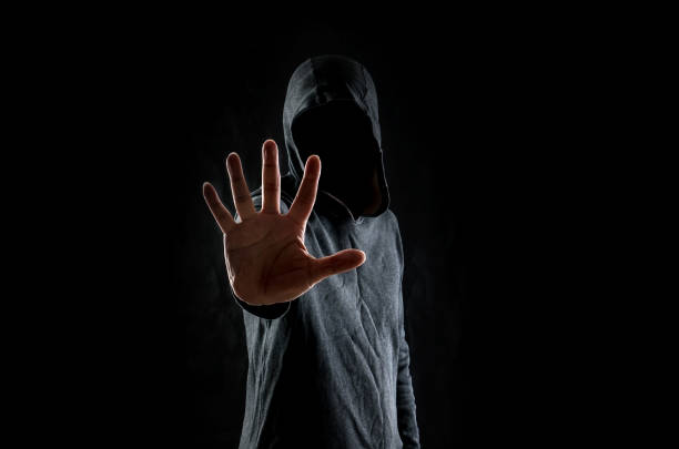 istock Men in hoodies in black background 1147313102