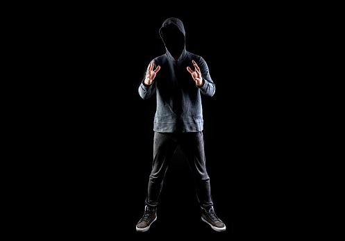 Men In Hoodies In Black Background Stock Photo - Download Image Now -  Computer Hacker, Studio Shot, Villain - iStock